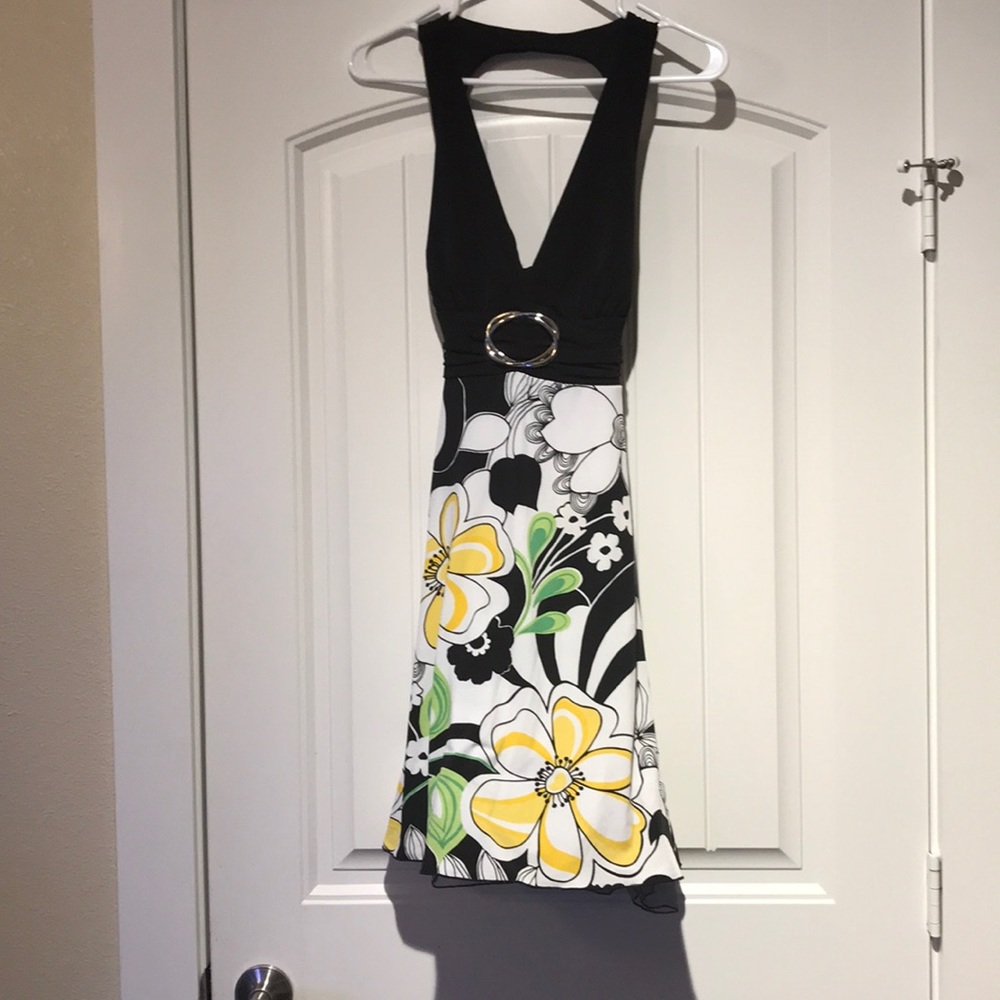 V-neck dress black top with flowers on bottom.